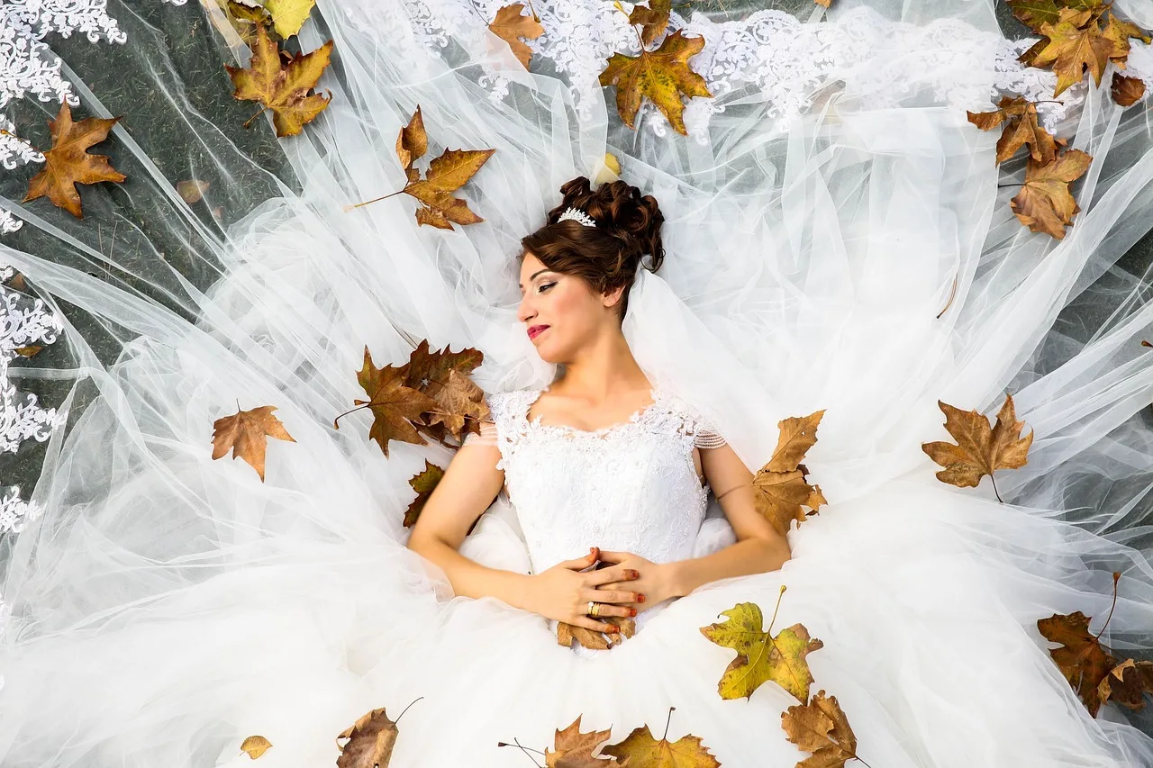 bride, wedding, lying down, wedding dress, wedding gown, model bride, modeling, white dress, wedding photography, white, love, marriage, woman, top view, autumn, bride, bride, bride, wedding, wedding, wedding, wedding, wedding, wedding dress, wedding dress, wedding photography. How the May to October season shapes cash flow for Alberta wedding coordinators
