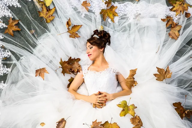 bride, wedding, lying down, wedding dress, wedding gown, model bride, modeling, white dress, wedding photography, white, love, marriage, woman, top view, autumn, bride, bride, bride, wedding, wedding, wedding, wedding, wedding, wedding dress, wedding dress, wedding photography. How the May to October season shapes cash flow for Alberta wedding coordinators